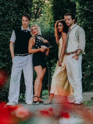 A fashionable group of adults posing in trendy summer outfits in a garden setting.