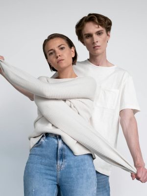 Fashion models posing in stylish outfits during a studio photoshoot.
