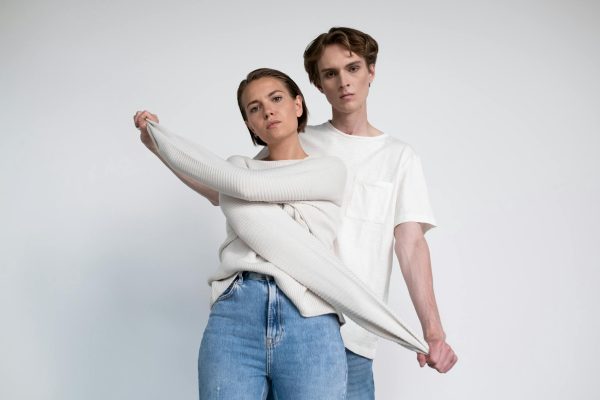 Fashion models posing in stylish outfits during a studio photoshoot.